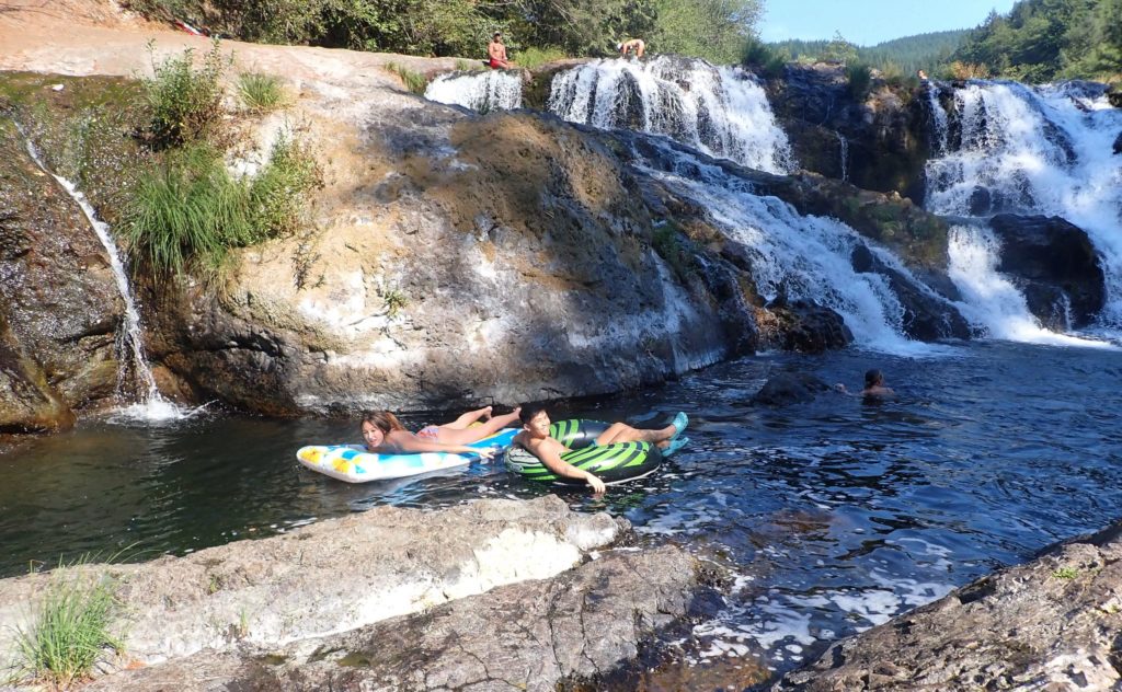 Teenagers floating on rafts at Dougan Falls