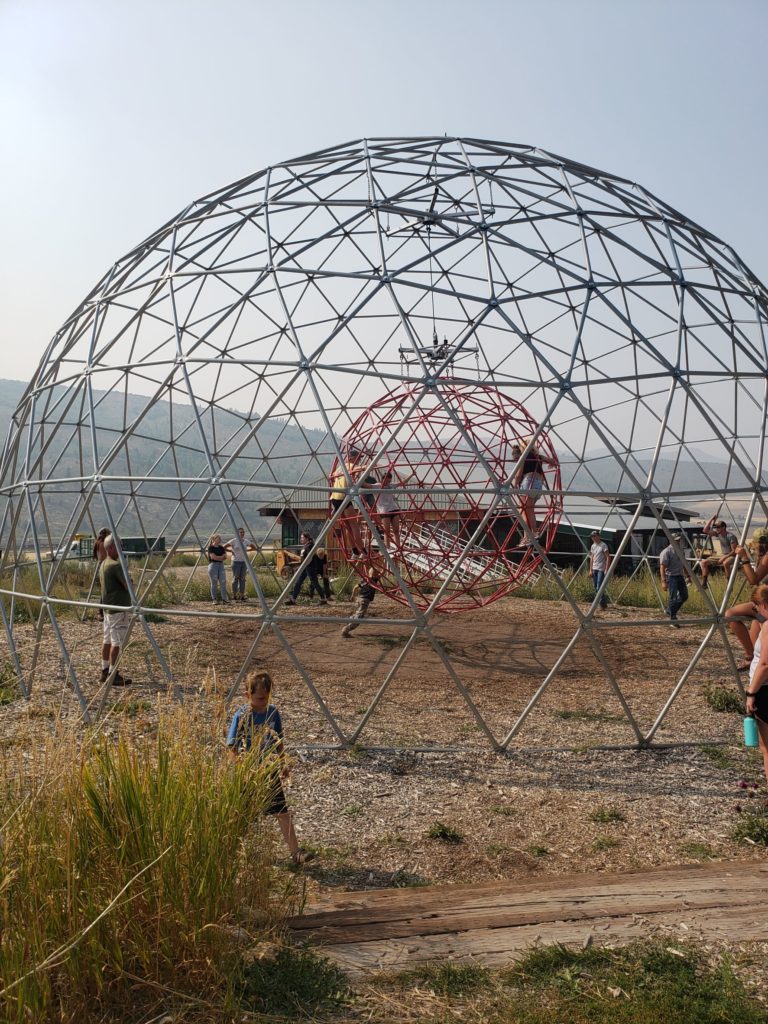 Playing in a spinning geodome at zipline adventures