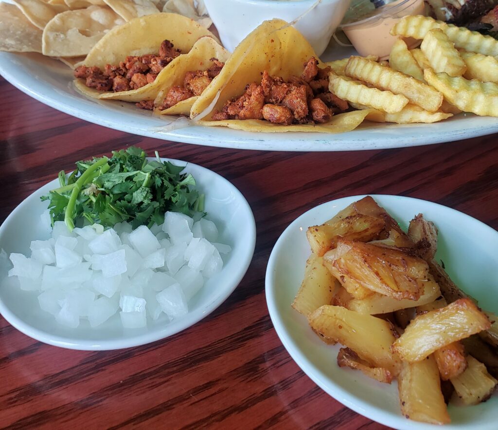 Pastor tacos shown on the sampler platter